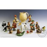 An assortment of collectable ceramics to include, six West German Goebel figures, a Wade jug,
