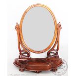 A Victorian mahogany dressing table mirror, with oval plate, on base with a box and scroll feet,