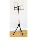 A Wheeldons Patent adjustable music stand, on turned tripod base, stamped,