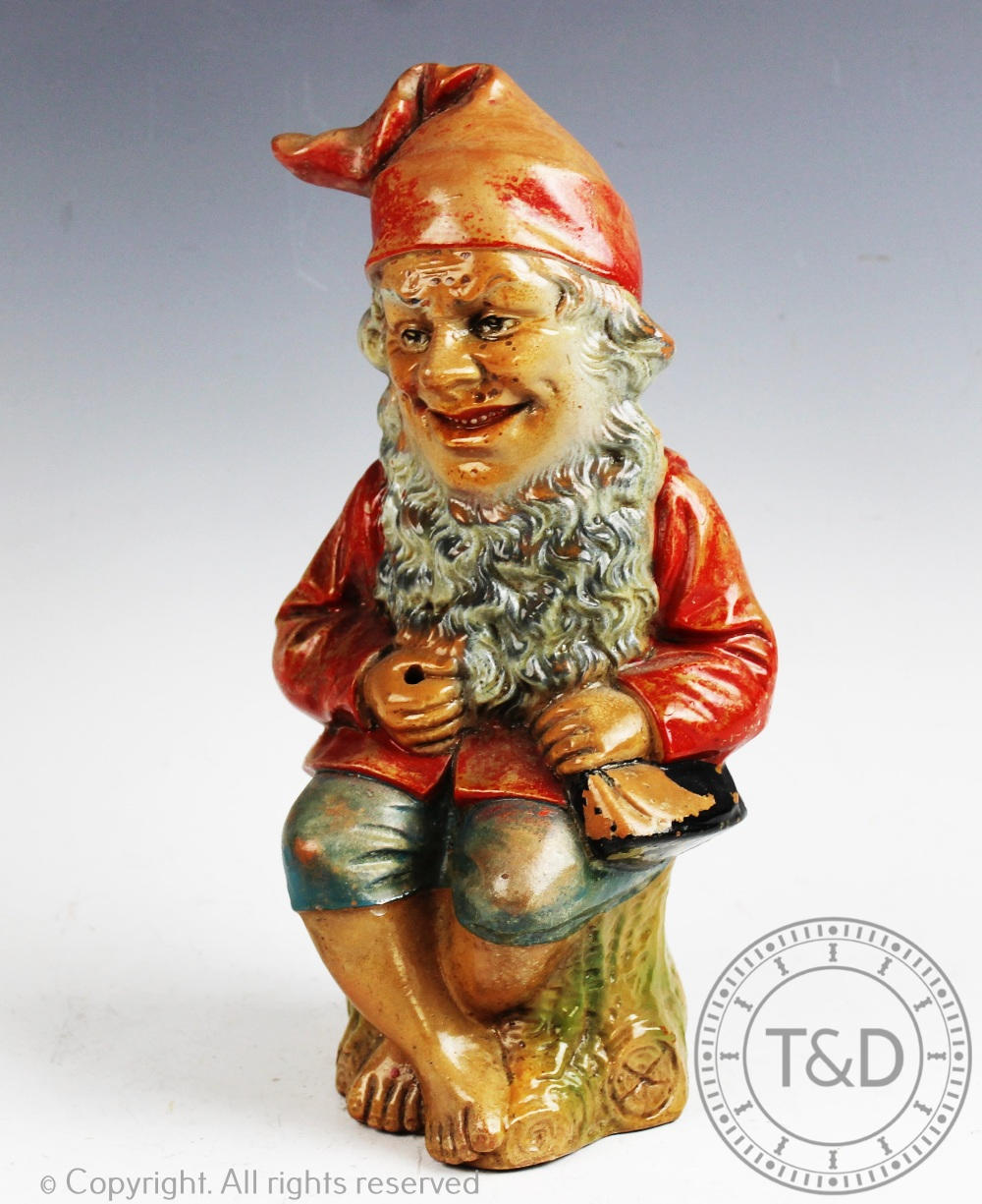 An early 20th century moulded and glazed terracotta garden gnome, possibly German,