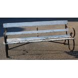 A late 19th / early 20th century wrought iron and slatted garden bench,