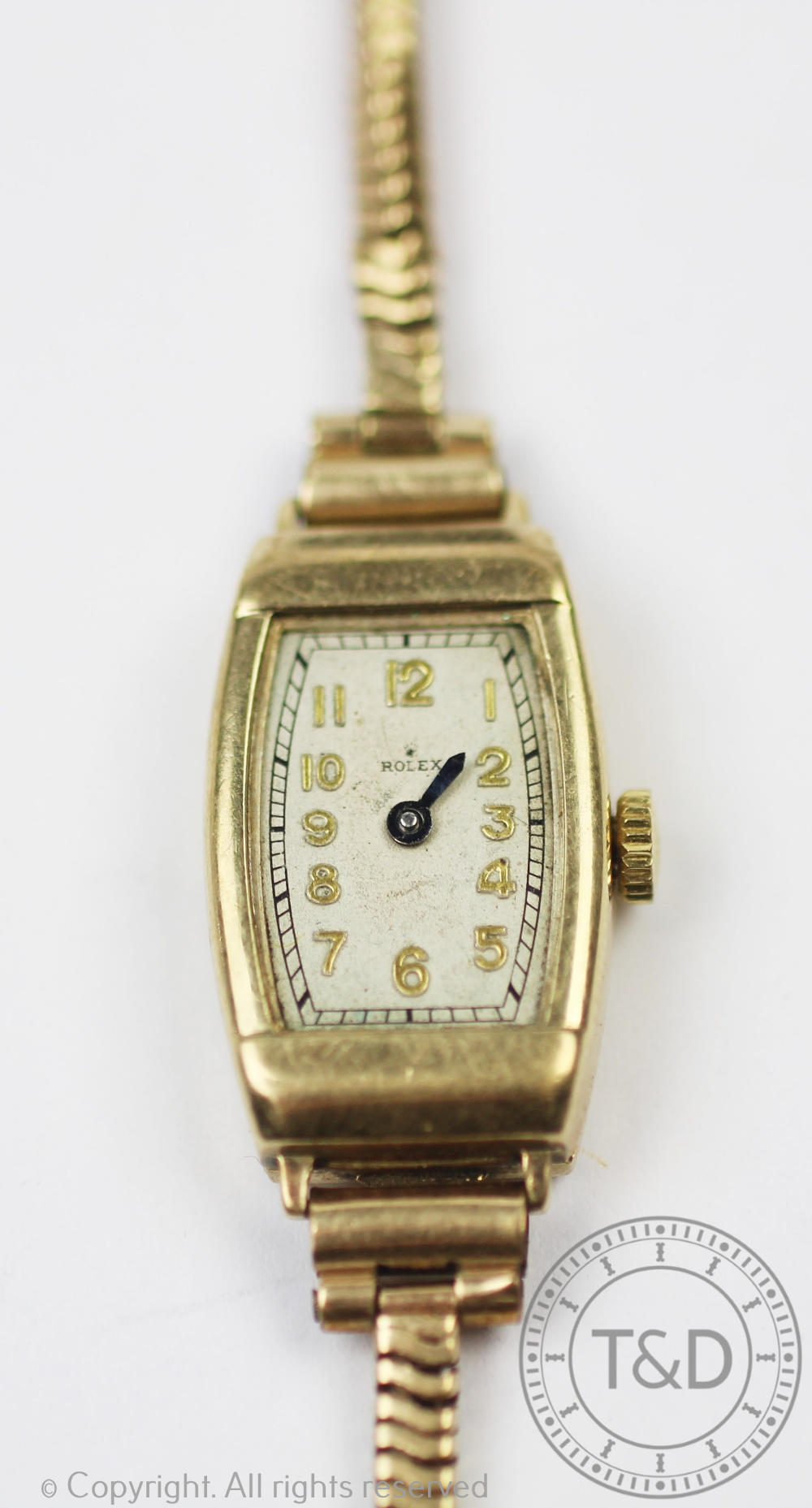 A 9ct gold Rolex wristwatch, the rectangular face enclosing silvered dial with gilt Arabic numerals,