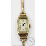 A 9ct gold Rolex wristwatch, the rectangular face enclosing silvered dial with gilt Arabic numerals,