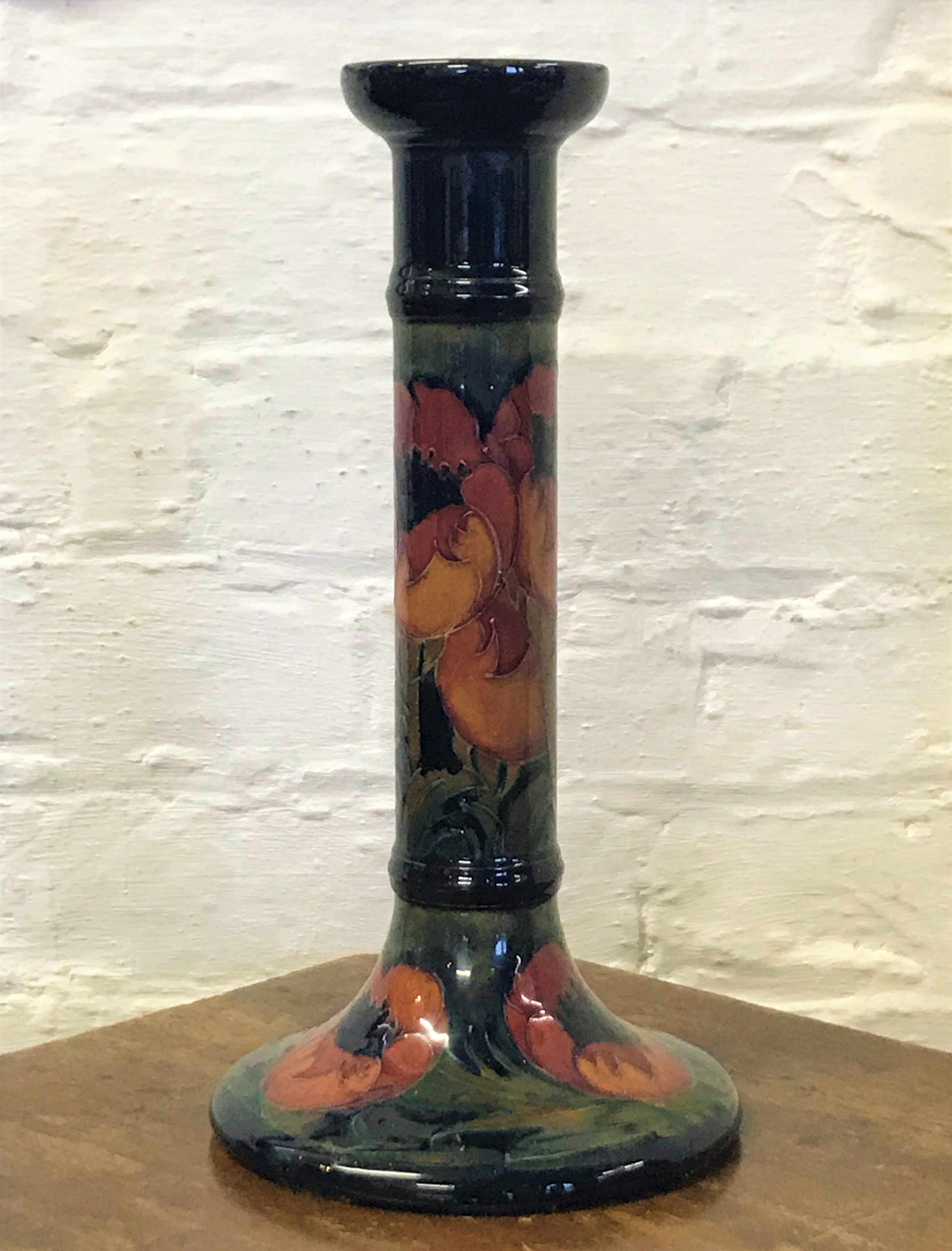 A Moorcroft candlestick converted to a lamp base, in a poppy pattern,