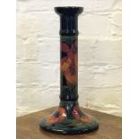A Moorcroft candlestick converted to a lamp base, in a poppy pattern,