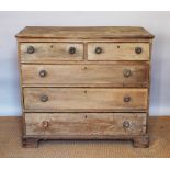 An early 19th century oak chest, of faded appearance, with two short and three long drawers,