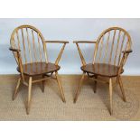 A pair of Ercol beech and ask chairs, with solid seats,
