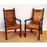 A pair of Victorian oak hall chairs, with tan leather backs and seats, on turned and block legs,