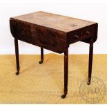 An early 19th century mahogany Pembroke table, with drawer, on fluted and turned tapered legs,