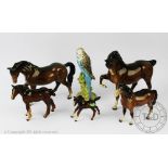 Five Beswick bay horses, highest 19cm and a Beswick Budgie,