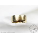 A 9ct yellow gold wedding band, 10mm wide, size W/X, gross weight 6.