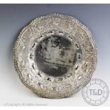 An Eastern white metal circular shallow dish,
