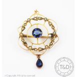 An Edwardian untested sapphire and seed pearl set brooch/pendant, of circular form,