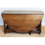 An 18th century style oak gate leg table, on turned and block legs with moulded stretchers,