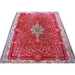 A machine woven wool carpet, worked with an all over floral design (worn),