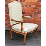 A French Louis XV style carved oak fauteuil, with upholstered back, arms and seat,
