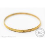 A yellow metal bangle stamped '22ct', 6.