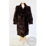 A full length beaver fur coat, with label for Philmoor London,