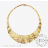 A tri-colour yellow gold necklace, the graduated fringe necklace with textured finish throughout,