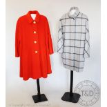 A bright orange mid length coat, bearing label for 'Jaeger',