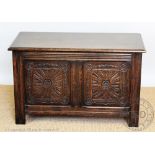 An early 20th century carved oak coffer, 56cm H x 91cm W x 46.