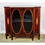 An Edwardian inlaid mahogany low display cabinet, with two oval glazed doors, on tapered legs, 95.