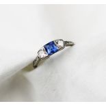 A sapphire and diamond three stone ring, early 20th century, the central square,