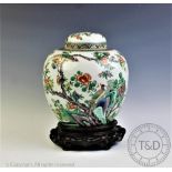 A 19th century Chinese famille vert ginger jar and cover, in Kangxi style, decorated with birds,