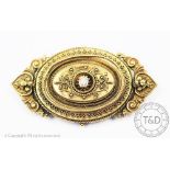 A diamond set Victorian brooch, the oval yellow metal brooch,