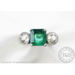 A diamond and emerald three stone ring,