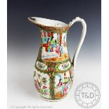 A late 19th century Chinese canton famille rose ewer, decorated in the typical style with figures,