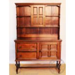 An early 20th century oak dresser, with panelled door above two drawers and a cupboard door,