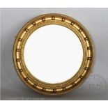 A Regency style giltwood and gesso circular convex wall mirror,