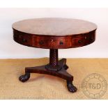 A Regency mahogany drum top library table / rent table, with three real and three dummy drawers,