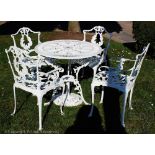 A modern white painted cast metal garden table and chairs,