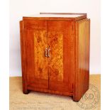 An Art Deco walnut and burr walnut cupboard, with two doors,