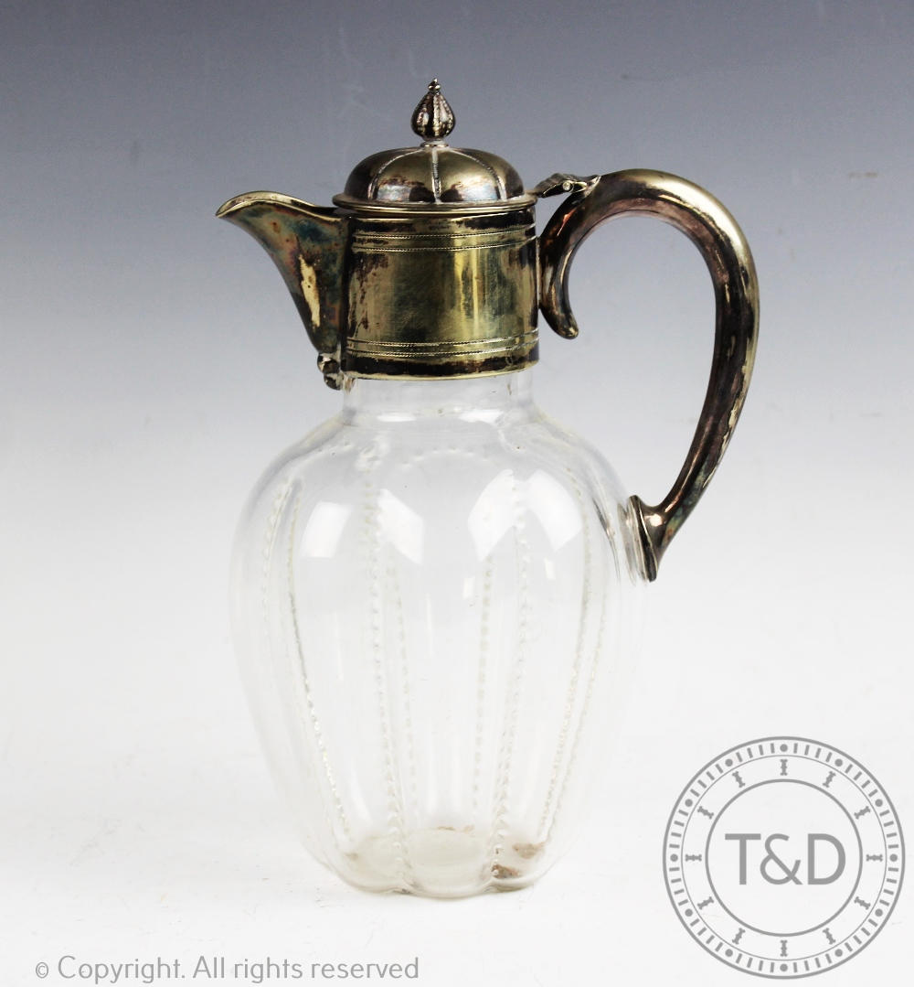 A Victorian silver plated claret jug, the glass body of lobed form,