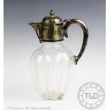 A Victorian silver plated claret jug, the glass body of lobed form,