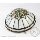 An Art Nouveau style light fitting, of rounded form set with stained glass panels,