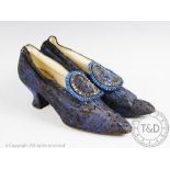 A pair of sapphire blue and black brocade evening shoes, circa 1910,