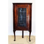 A 19th century mahogany corner cabinet, with astragal glazed door, on cabriole legs and pad feet,