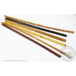 Six assorted Military swagger sticks to include a Kings Regiment example, 70cm long,