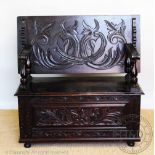 An early 20th century carved oak monks seat / bench,