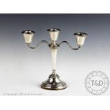 A silver candelabrum, Elkington & Co, Birmingham 1967, on a circular foot with laurel borders,