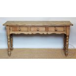 A Victorian style pine dairy dresser, with three drawers, on turned legs,
