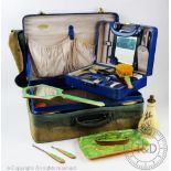 An Art Deco blue enamel travelling vanity case, within a larger travelling case,