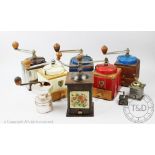 A collection of coffee grinders, to include; three Peugeot Freres 1930's painted examples,