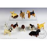 A selection of ten Beswick dogs to include a Chihuahua seated on a bed, a pug, yellow Labrador,