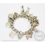 A silver curb link bracelet hung with numerous charms including; a boxer dog, a cocker spaniel,