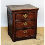 A George III style oak chest, with three drawers, on stile feet,